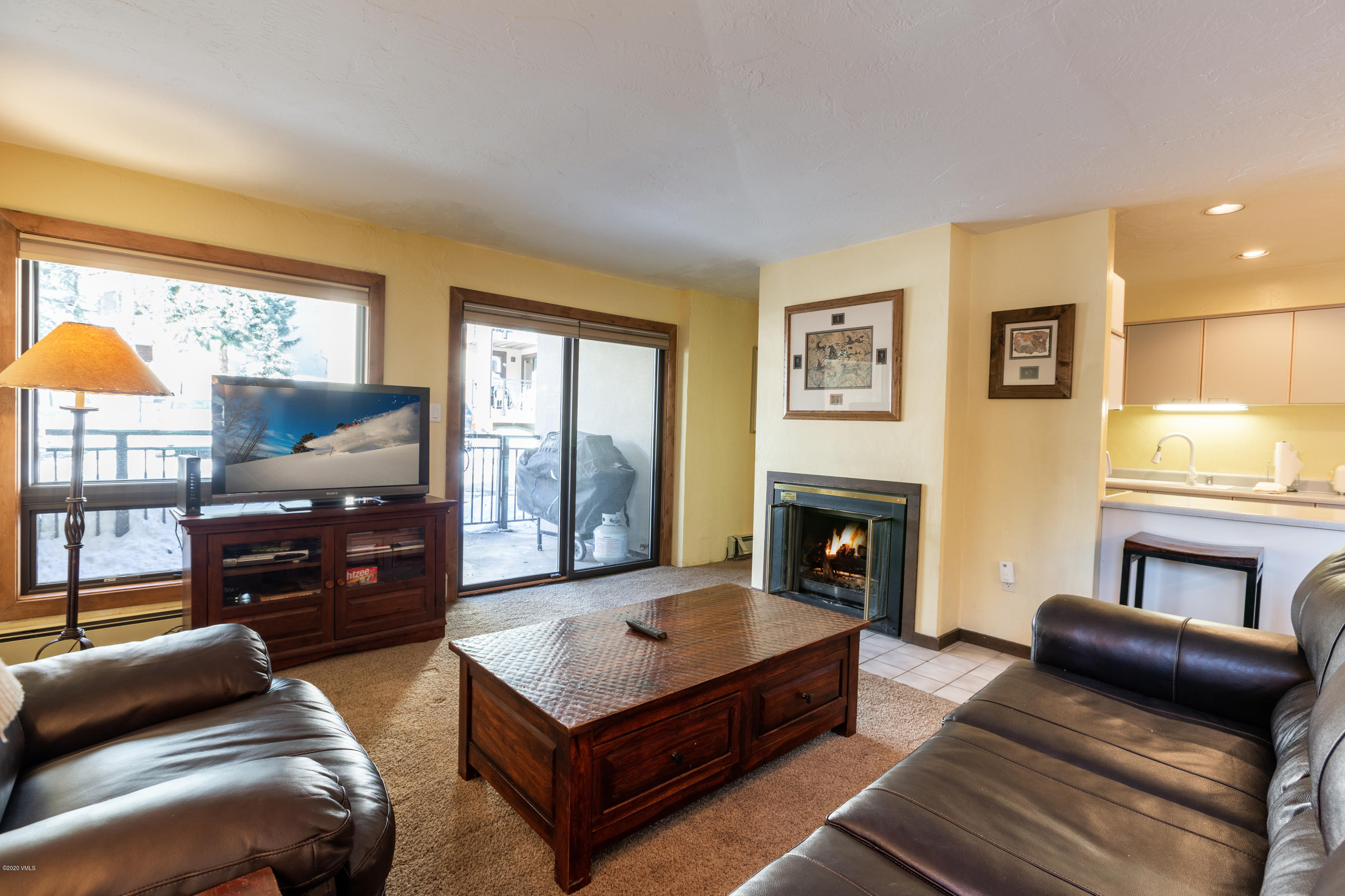 963 Lions Ridge Loop, Unit 501 Vail, CO 81657 - Photo 3 of 9 a living room with furniture flat screen tv and a fireplace