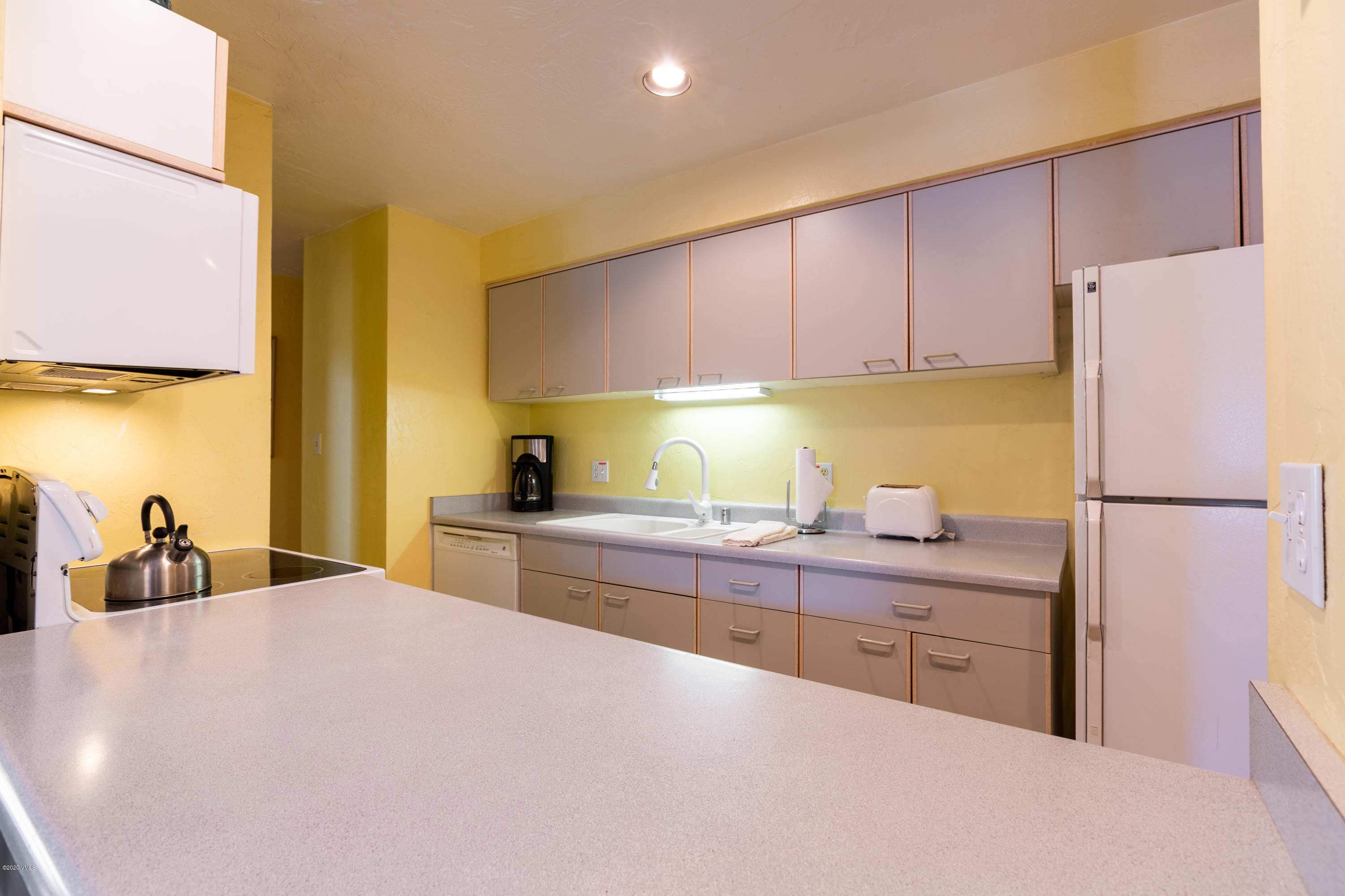 963 Lions Ridge Loop, Unit 501 Vail, CO 81657 - Photo 4 of 9 a kitchen with a sink a stove and a refrigerator
