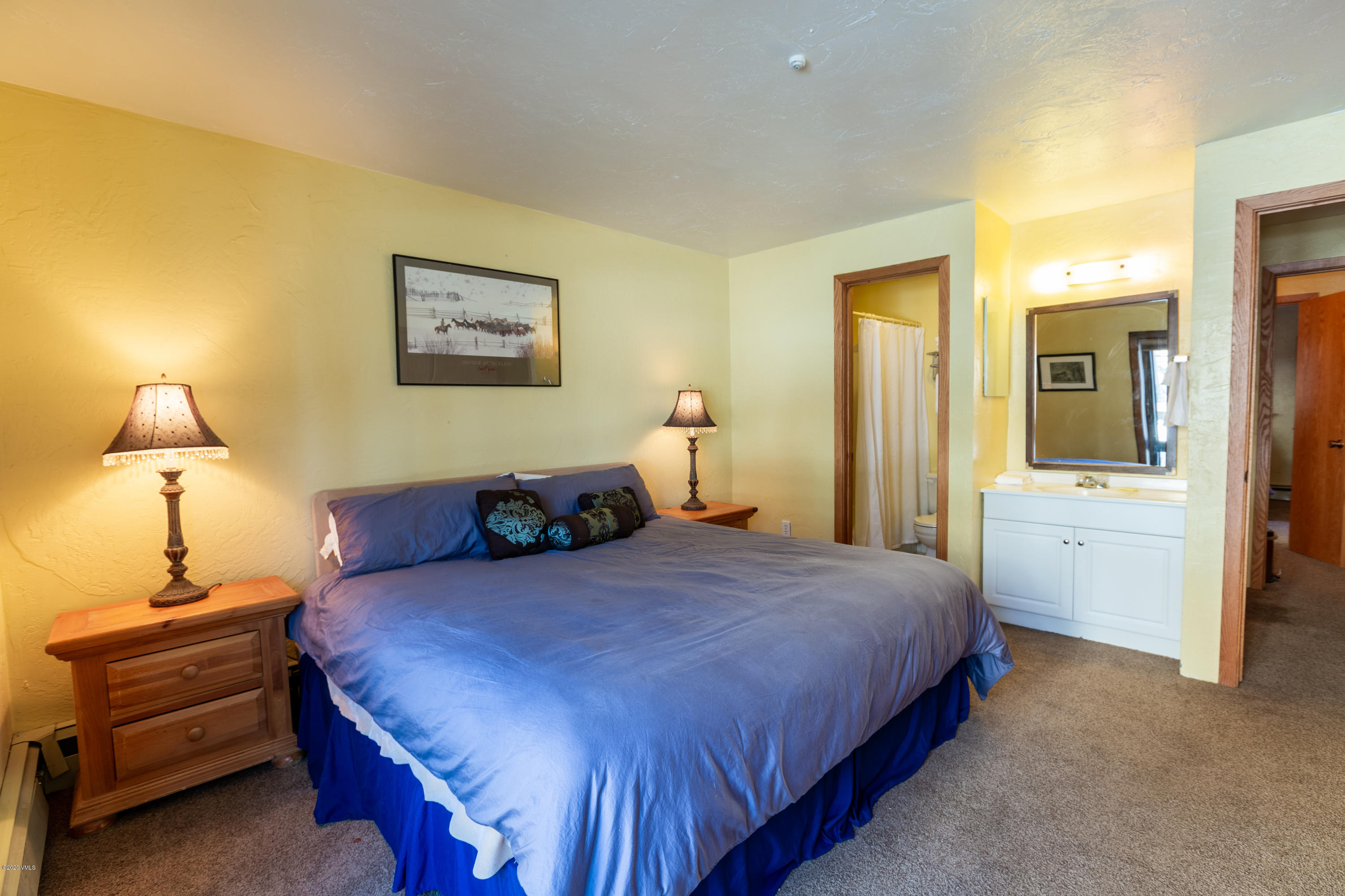 963 Lions Ridge Loop, Unit 501 Vail, CO 81657 - Photo 5 of 9 a bedroom with a bed and a lamp