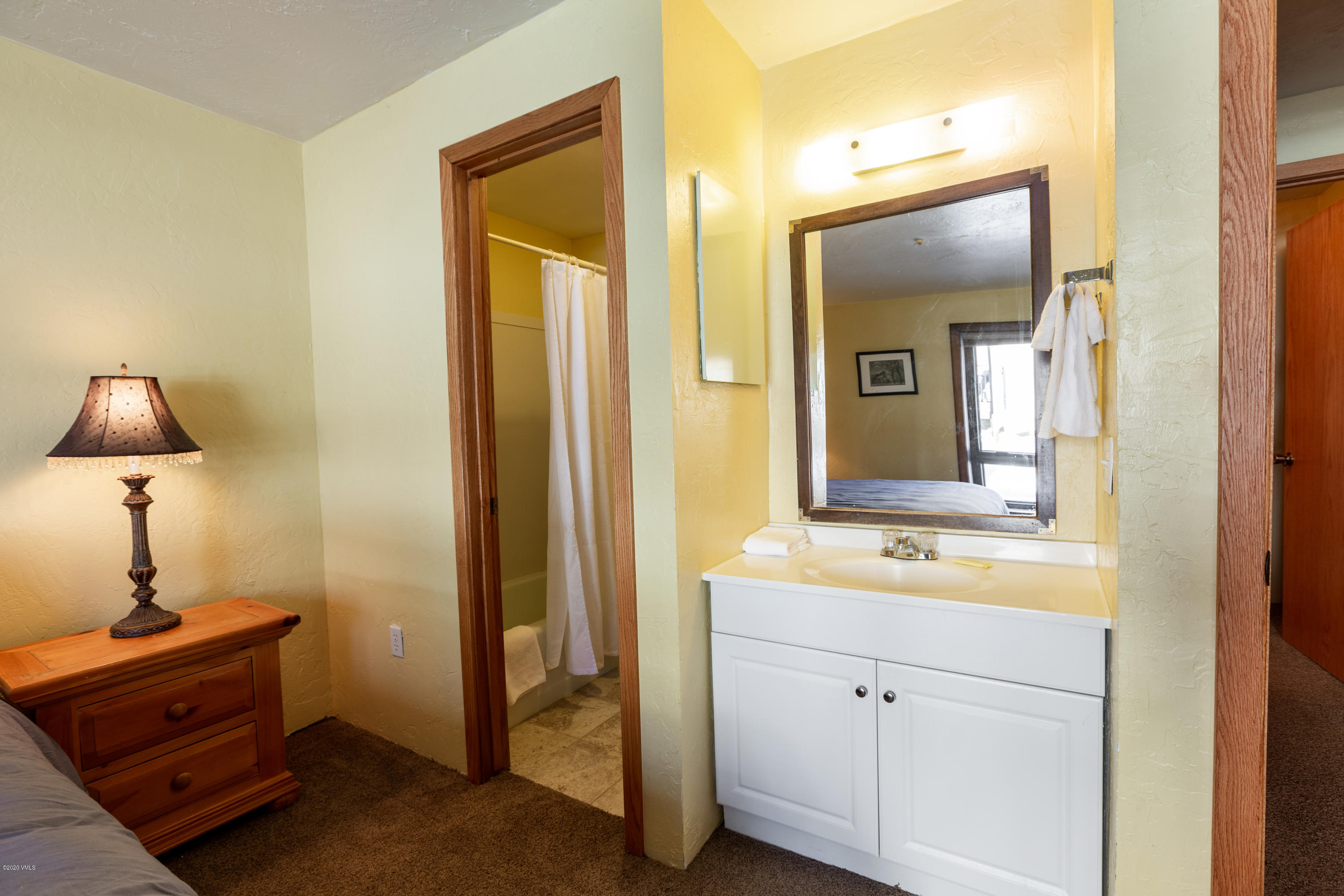 963 Lions Ridge Loop, Unit 501 Vail, CO 81657 - Photo 6 of 9 a en suite bathroom with a sink and a mirror