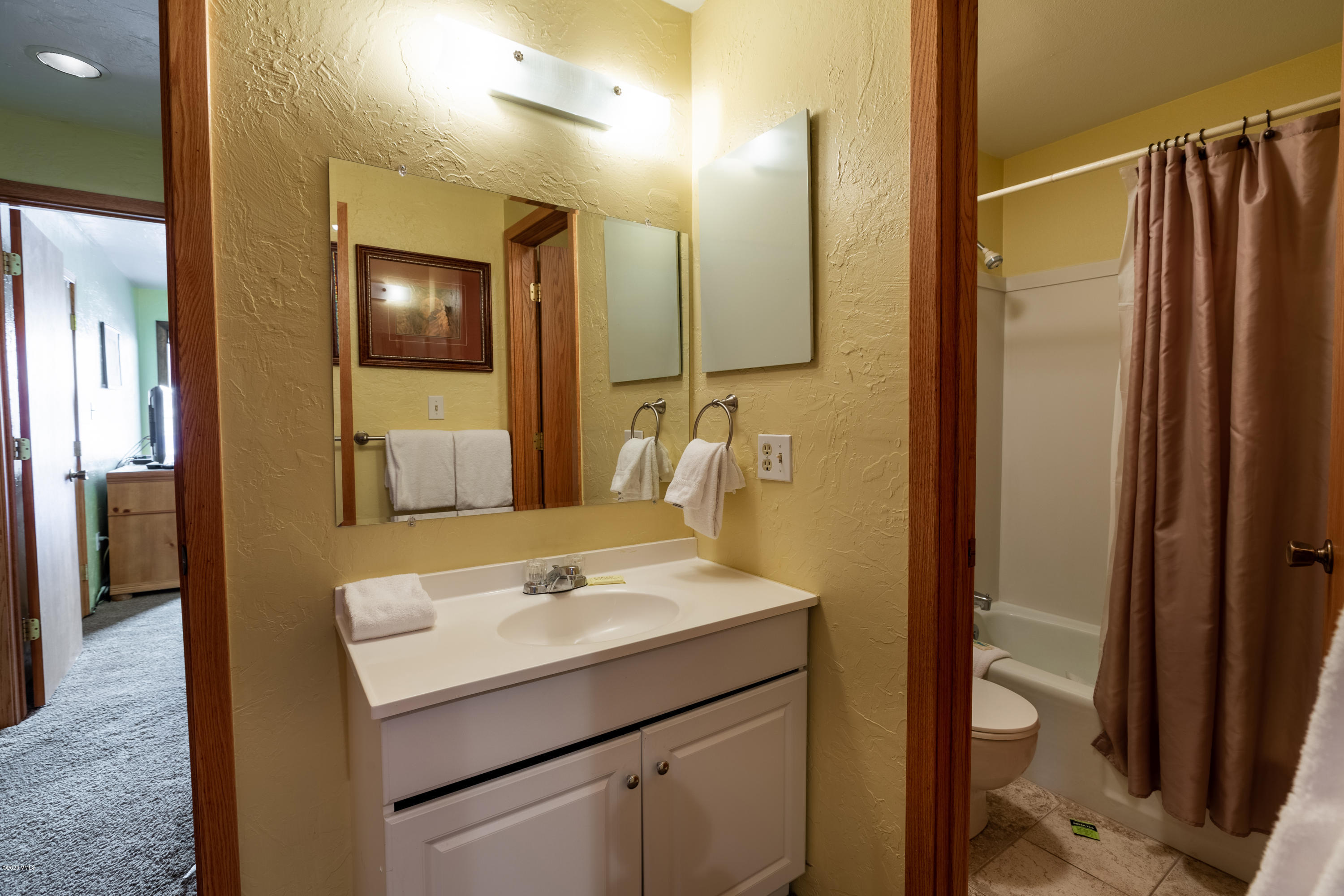 963 Lions Ridge Loop, Unit 501 Vail, CO 81657 - Photo 8 of 9 a bathroom with a sink a toilet and shower