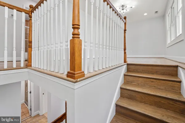 a view of entryway with wooden floor and staircase