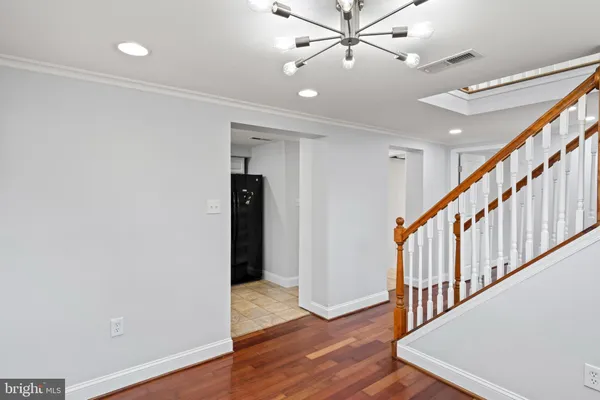 a kitchen with stainless steel appliances granite countertop a stove a microwave and a wooden floor