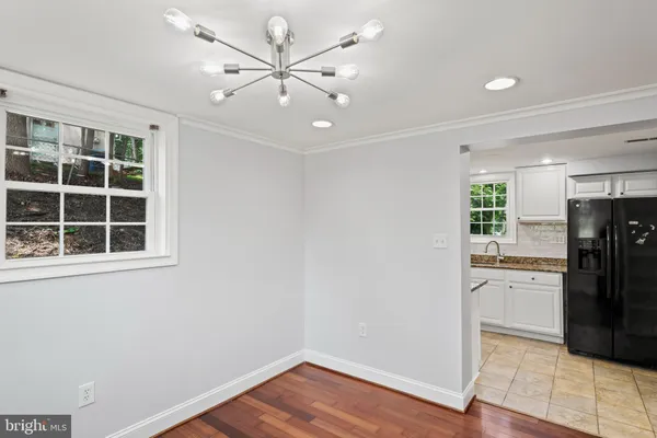 a kitchen with stainless steel appliances granite countertop white cabinets a microwave oven and a granite counter tops