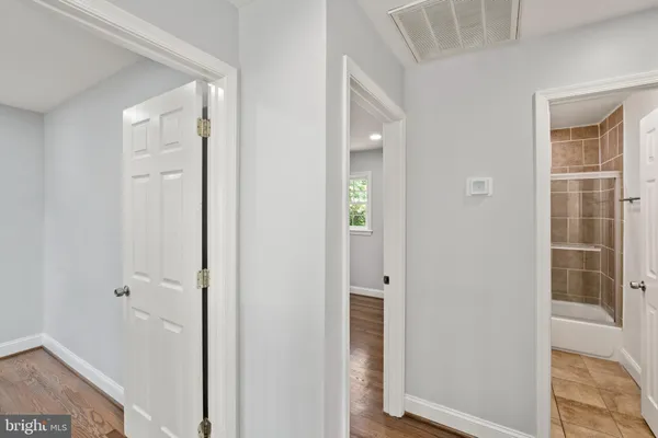 a view of a hallway with entryway wooden floor and front door