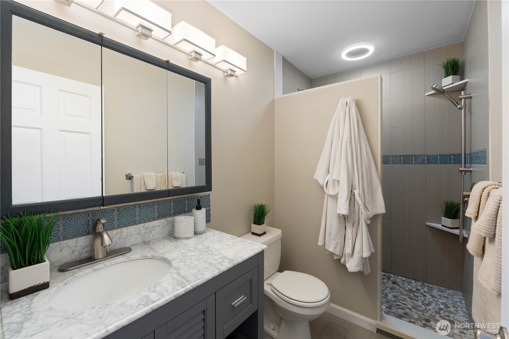 1211 Maybelle Street Sumner, WA 98390 - Photo 15 of 38 a bathroom with a granite countertop sink toilet and shower