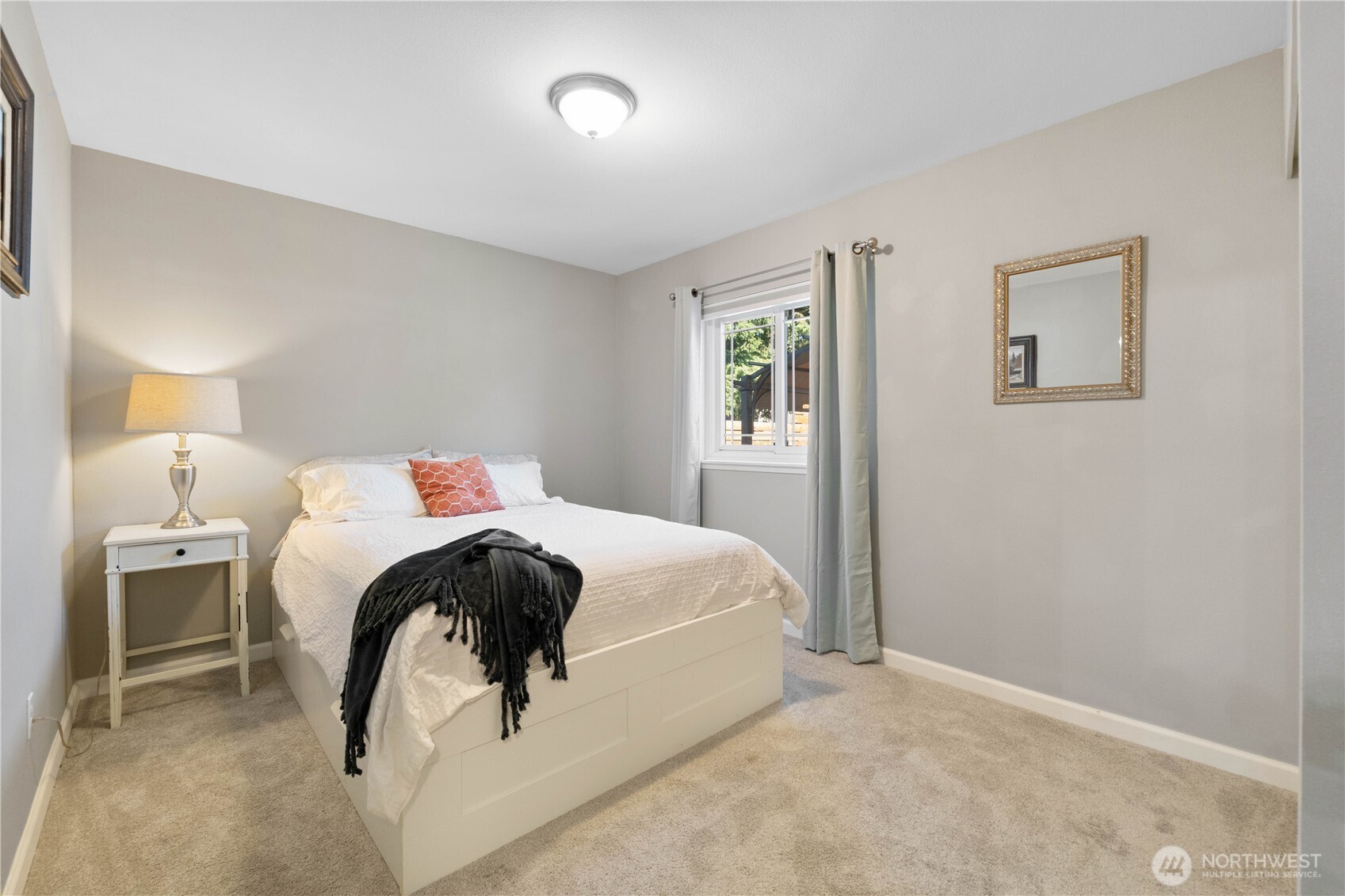 1211 Maybelle Street Sumner, WA 98390 - Photo 17 of 38 a bedroom with a bed and a lamp