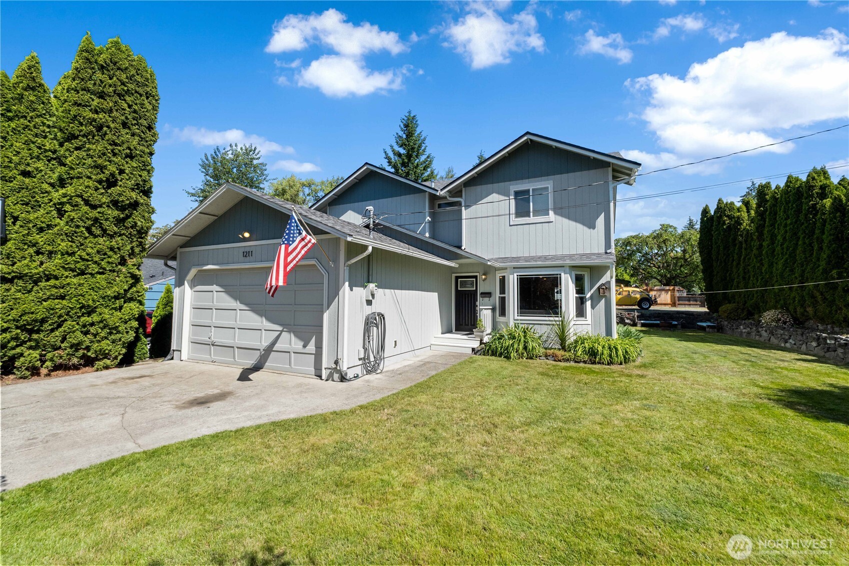 1211 Maybelle Street Sumner, WA 98390 - Photo 2 of 38 a front view of a house with garden