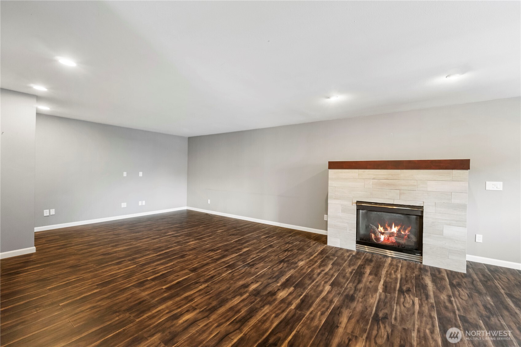 1211 Maybelle Street Sumner, WA 98390 - Photo 21 of 38 a view of an empty room with a fireplace and a window