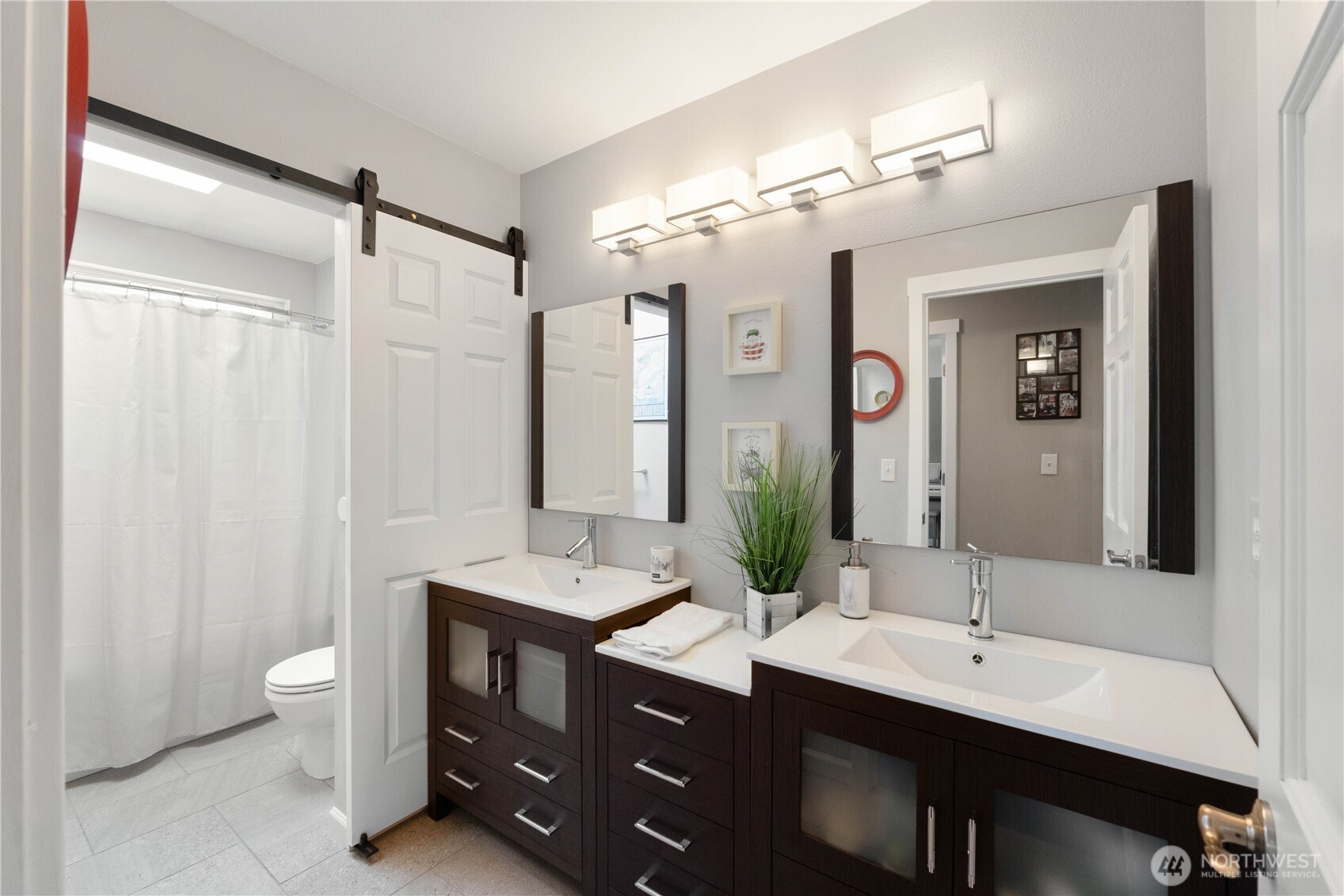 1211 Maybelle Street Sumner, WA 98390 - Photo 27 of 38 a bathroom with double vanity sinks a toilet a mirror and shower