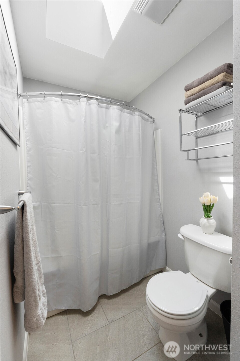 1211 Maybelle Street Sumner, WA 98390 - Photo 28 of 38 a white toilet sitting next to a shower curtain