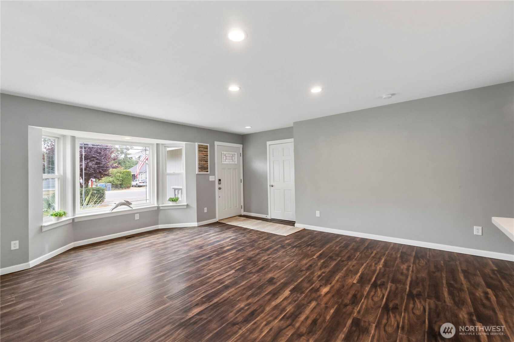 1211 Maybelle Street Sumner, WA 98390 - Photo 6 of 38 a view of an empty room with wooden floor and a window