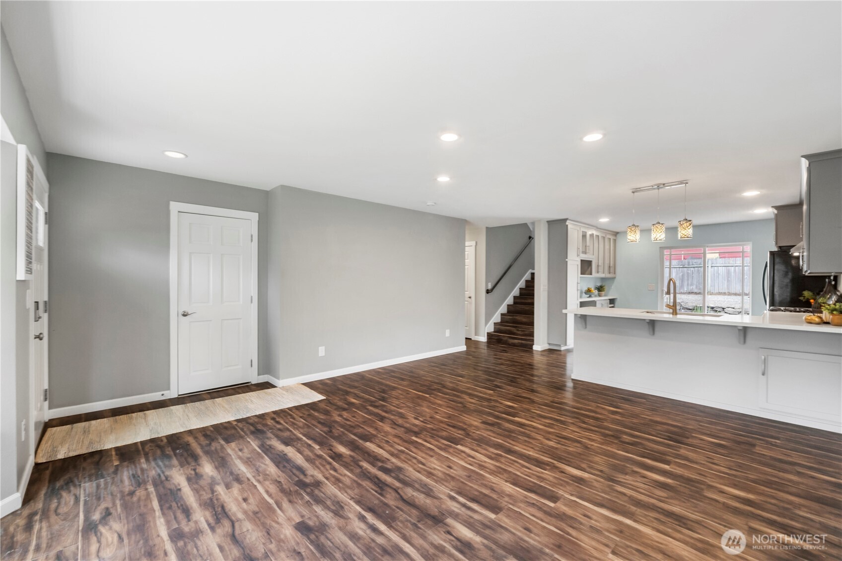 1211 Maybelle Street Sumner, WA 98390 - Photo 7 of 38 a view of a kitchen with wooden floor and a sink