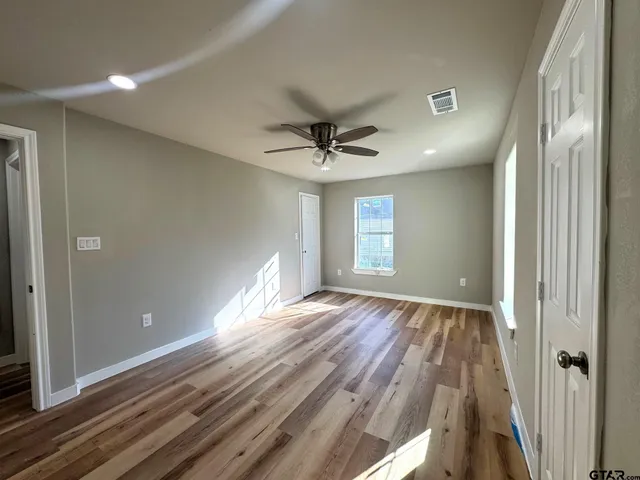 wooden floor in an empty room with a window