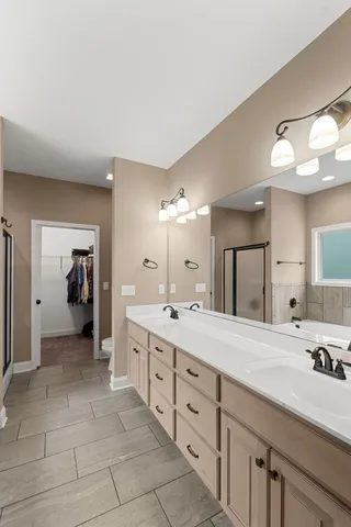 a spacious bathroom with a granite countertop sink a mirror and a
