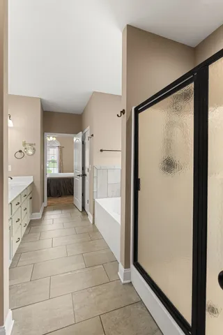 a bathroom with a glass shower door and a glass door
