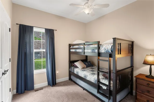 a bedroom with a bed and large window