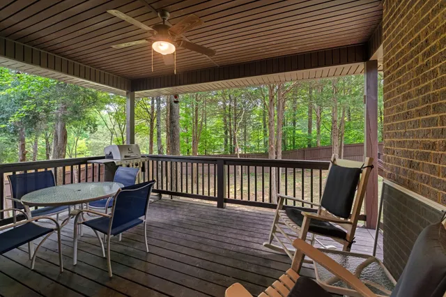 a view of a porch with furniture and wooden floor