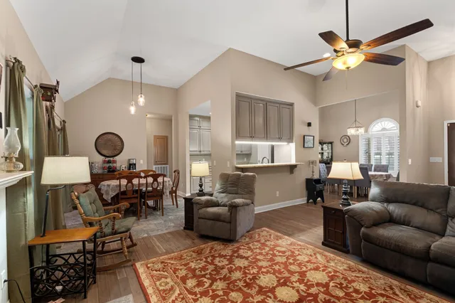 a living room with furniture and a chandelier