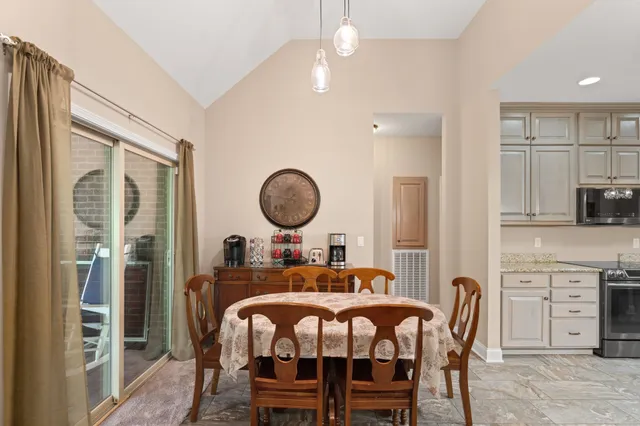 a view of dining room and kitchen with a table chairs and entryway
