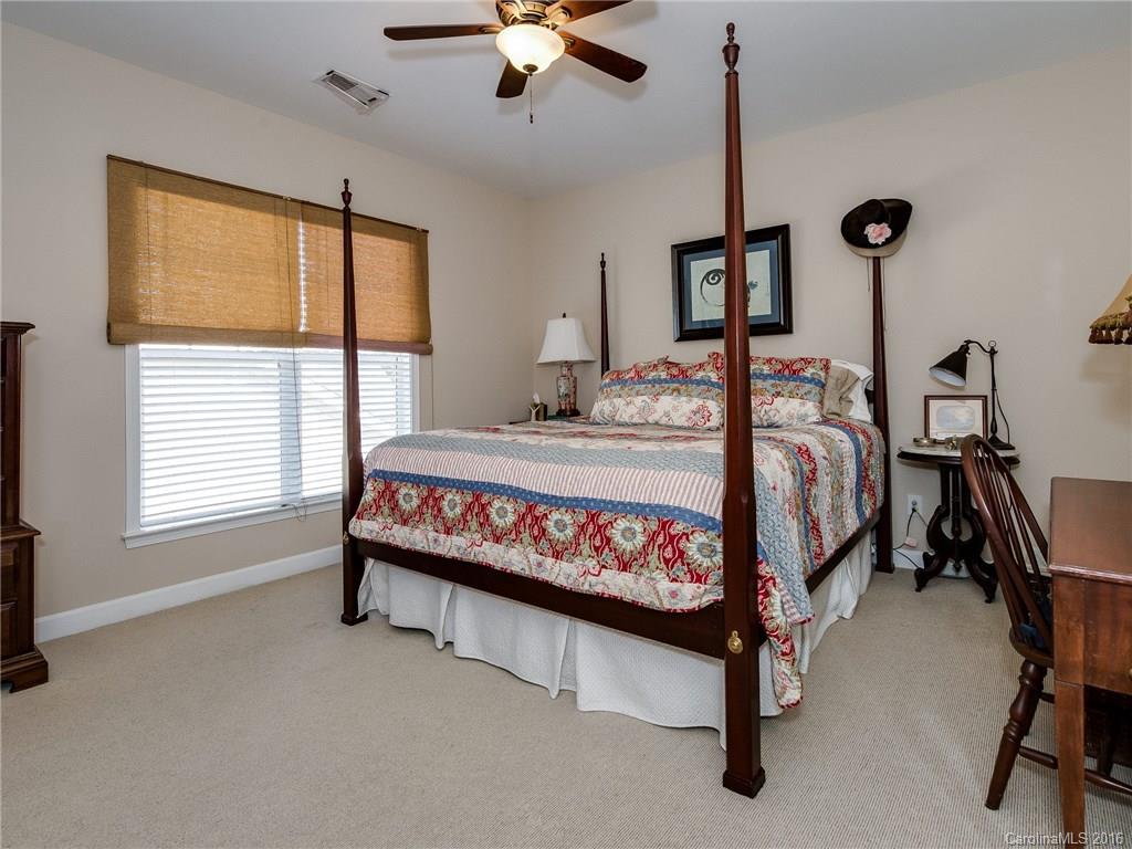 4160 Walker Road Charlotte, NC 28211 - Photo 11 of 13 a bedroom with a bed a chandelier and next to a window