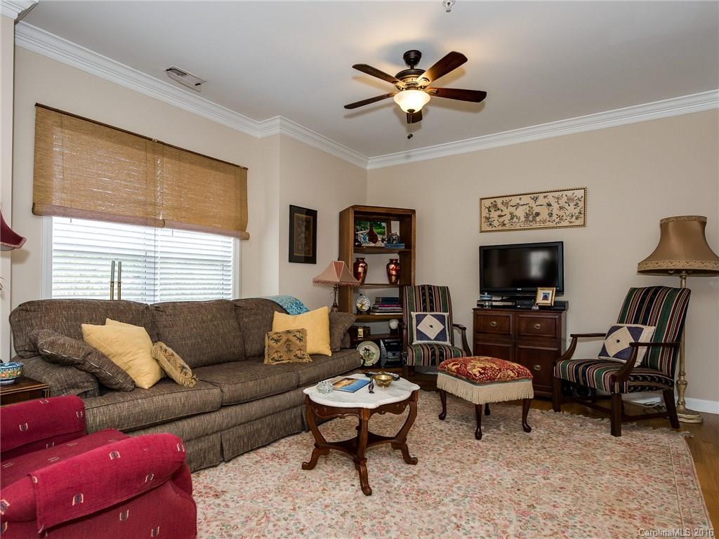 4160 Walker Road Charlotte, NC 28211 - Photo 3 of 13 a living room with furniture a chandelier and a window