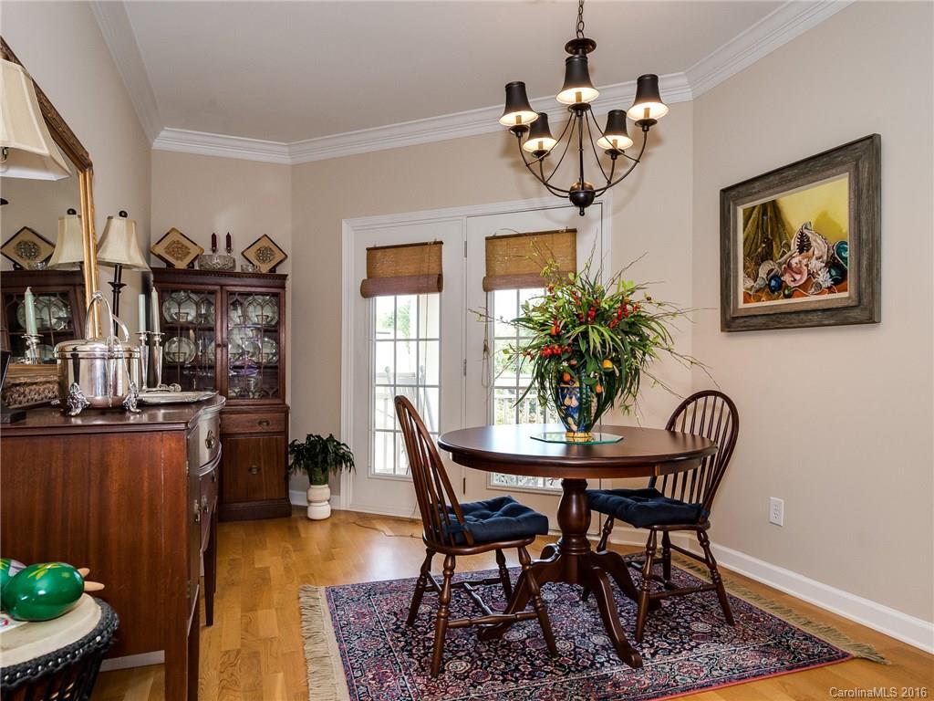 4160 Walker Road Charlotte, NC 28211 - Photo 4 of 13 a view of a dining room with furniture a chandelier and wooden floor