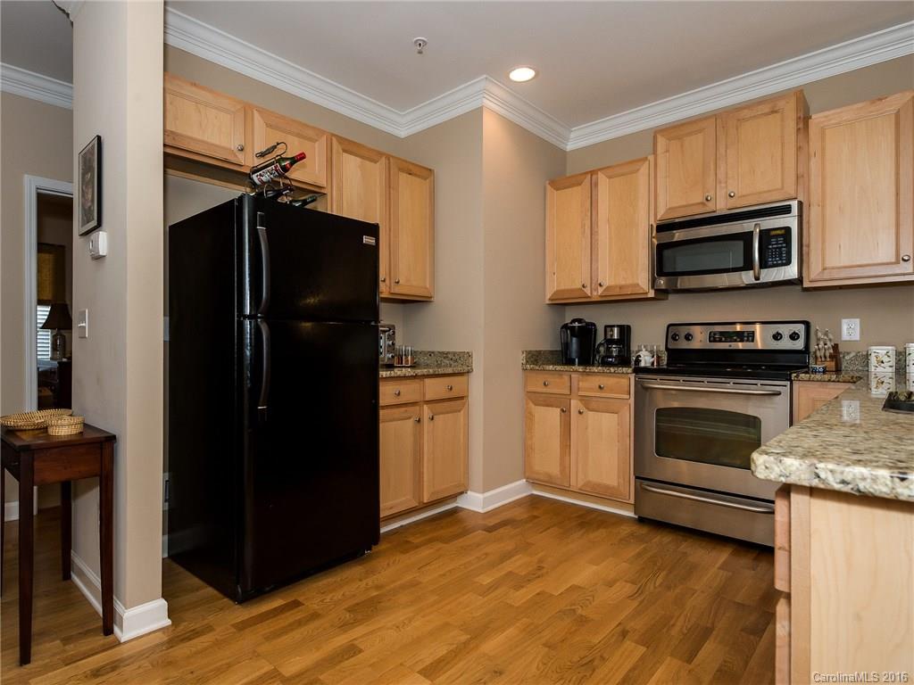 4160 Walker Road Charlotte, NC 28211 - Photo 7 of 13 a kitchen with a refrigerator and a stove top oven