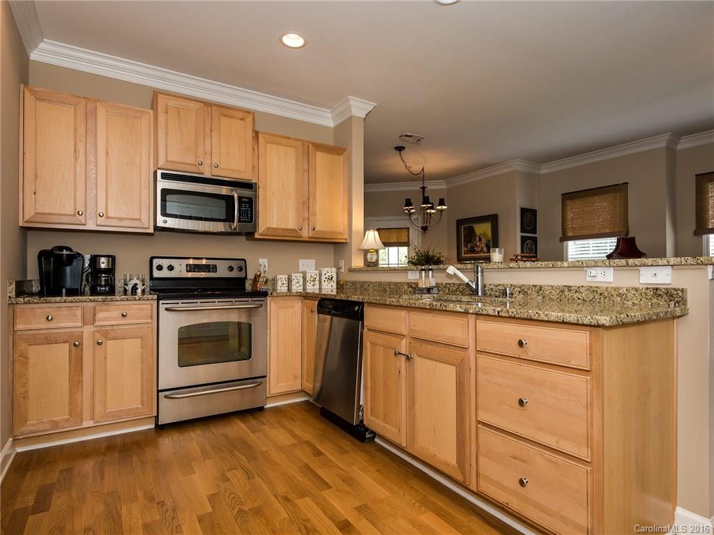 4160 Walker Road Charlotte, NC 28211 - Photo 8 of 13 a kitchen with granite countertop cabinets stainless steel appliances and a sink