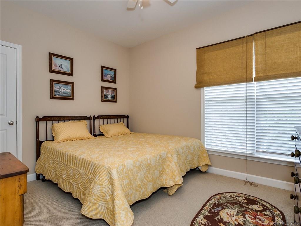 4160 Walker Road Charlotte, NC 28211 - Photo 9 of 13 a bedroom with a bed and lamp