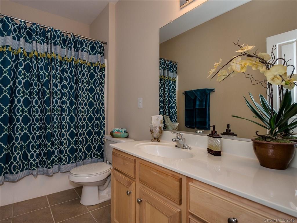 4160 Walker Road Charlotte, NC 28211 - Photo 10 of 13 a bathroom with a sink a toilet a mirror and shower