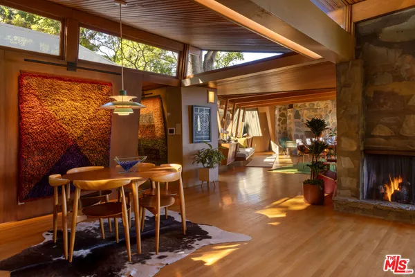 a view of a patio with table and chairs under an umbrella