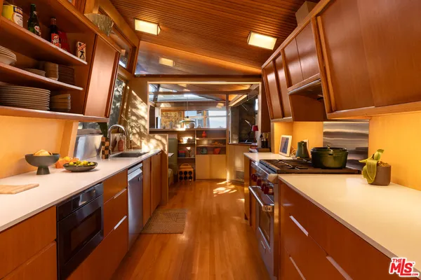 a kitchen with a sink and wooden cabinets