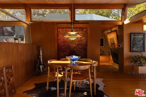 a dining room with furniture and window