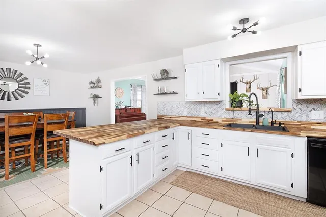 a kitchen with granite countertop white cabinets and white appliances