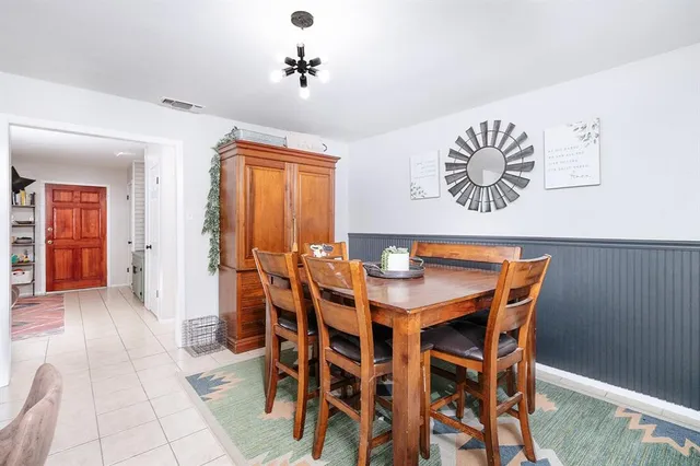 a large white kitchen with a stove a sink dishwasher and a refrigerator with wooden floor