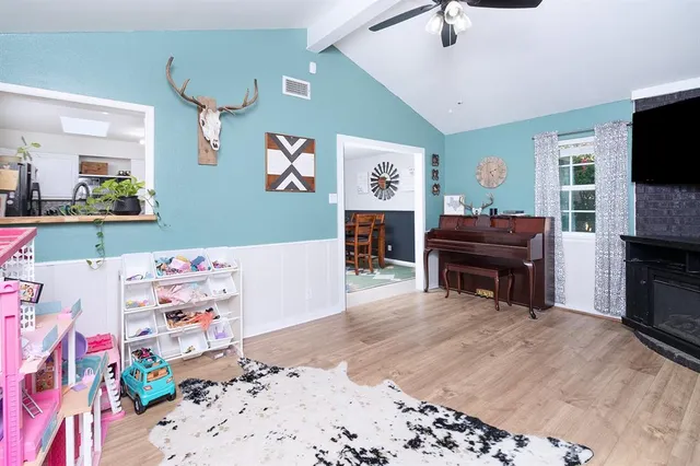 a room with a bed and a television