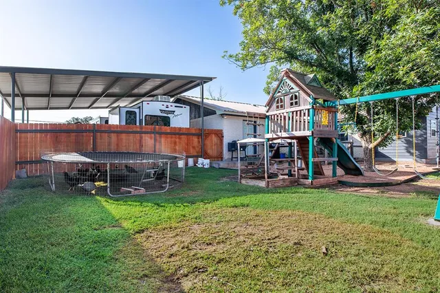 a view of a house with a yard and sitting area