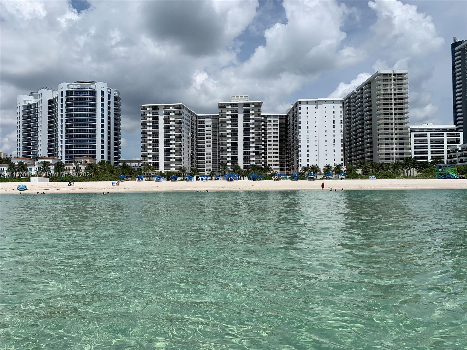6039 Collins Avenue, Unit 1630 Miami Beach, FL 33140 - Photo 1 of 37 a view of lake with tall building