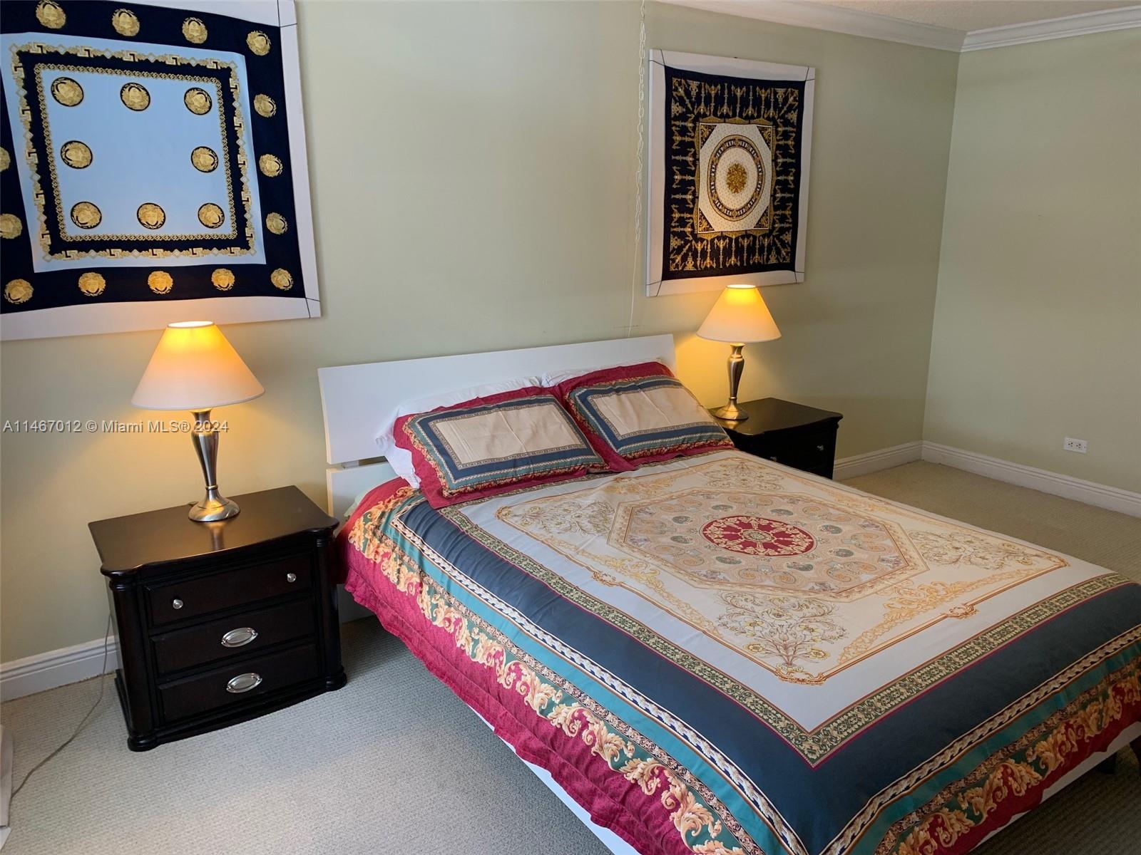 6039 Collins Avenue, Unit 1630 Miami Beach, FL 33140 - Photo 12 of 37 a bed room with a bed and painting on the wall