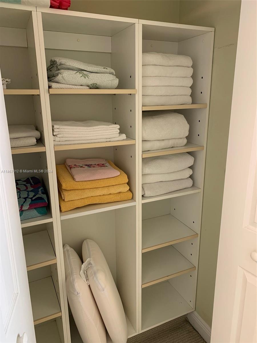 6039 Collins Avenue, Unit 1630 Miami Beach, FL 33140 - Photo 13 of 37 a storage room with washer and dryer