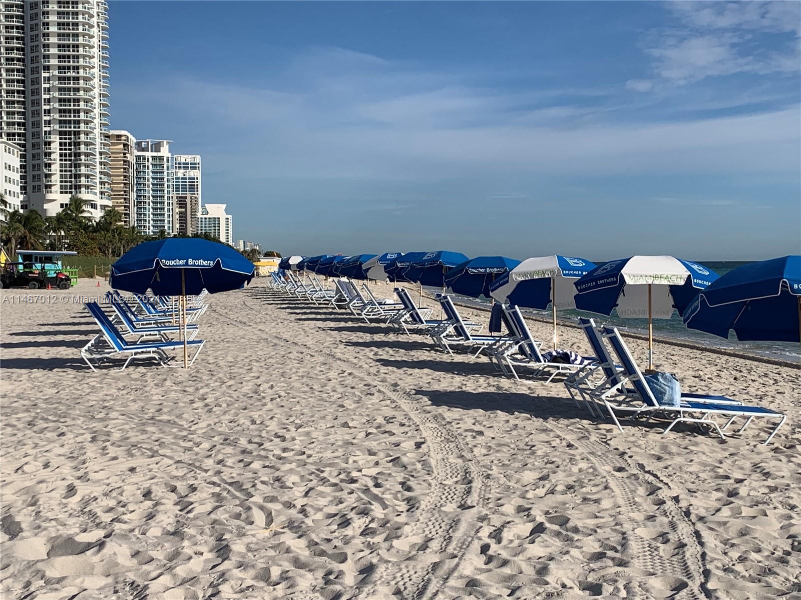 6039 Collins Avenue, Unit 1630 Miami Beach, FL 33140 - Photo 31 of 37 a view of a backyard with table and chairs