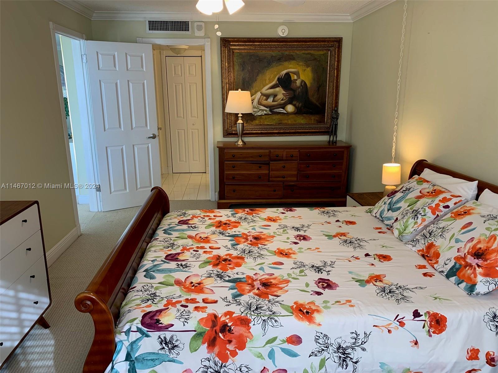 6039 Collins Avenue, Unit 1630 Miami Beach, FL 33140 - Photo 5 of 37 a bed sitting in a bedroom next to a window