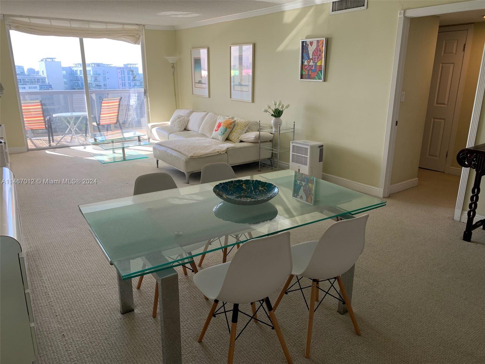 6039 Collins Avenue, Unit 1630 Miami Beach, FL 33140 - Photo 6 of 37 a dining room with furniture and a window