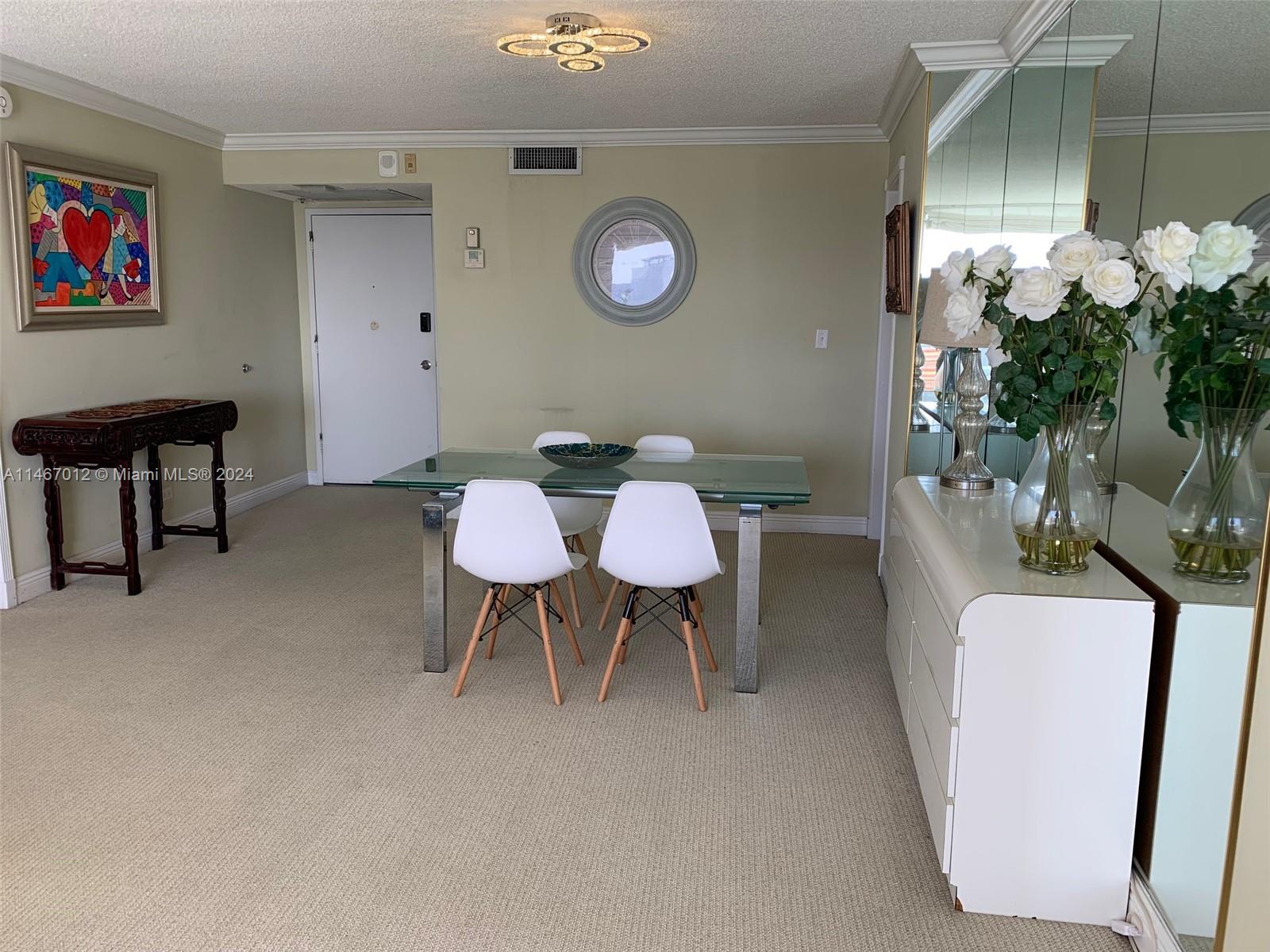 6039 Collins Avenue, Unit 1630 Miami Beach, FL 33140 - Photo 9 of 37 a view of a livingroom with furniture and a potted plant