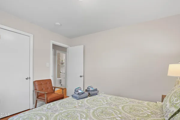 a bedroom with a bed and chair