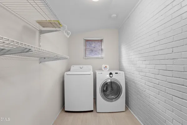 a front view of house with yard and trees in the background