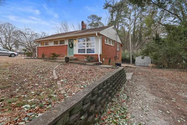 a view of a house with a yard covered with snow in the background
