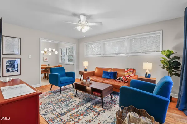 a living room with furniture a rug and a window