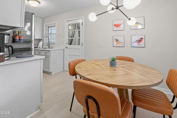 a kitchen with stainless steel appliances white cabinets and a refrigerator